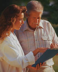 Fotografía de una médico revisando un historial médico con un paciente