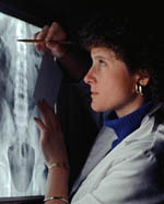 Picture of a female radiologist reading an x-ray